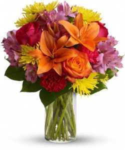 Express yourself colorfully with a brilliant array of roses, lilies and other favorites beautifully arranged in a sparkling clear glass cylinder vase.