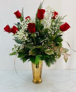 12 gorgeous red roses accented by fresh pine for the season.