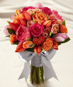 Orange tulips, peach spray roses, pink garden roses, fuchsia roses, light orange tulips, light pink tulips and orange spray roses