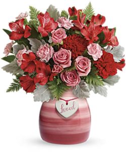 Playful red and pink roses and radiant red blooms look oh-so wonderful in this hand-painted ceramic vase, adorned with a charming "loved" heart charm.