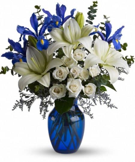Striking design of white lilies and complimenting flowers in this cobalt blue vase reflect a very distinctive look and feel. Very romantic...