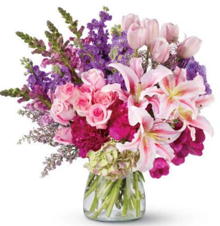 this dramatic arrangement of roses, peonies, lilies, tulips and more - in radiant, blushing shades of pink and purple - is fit for royalty